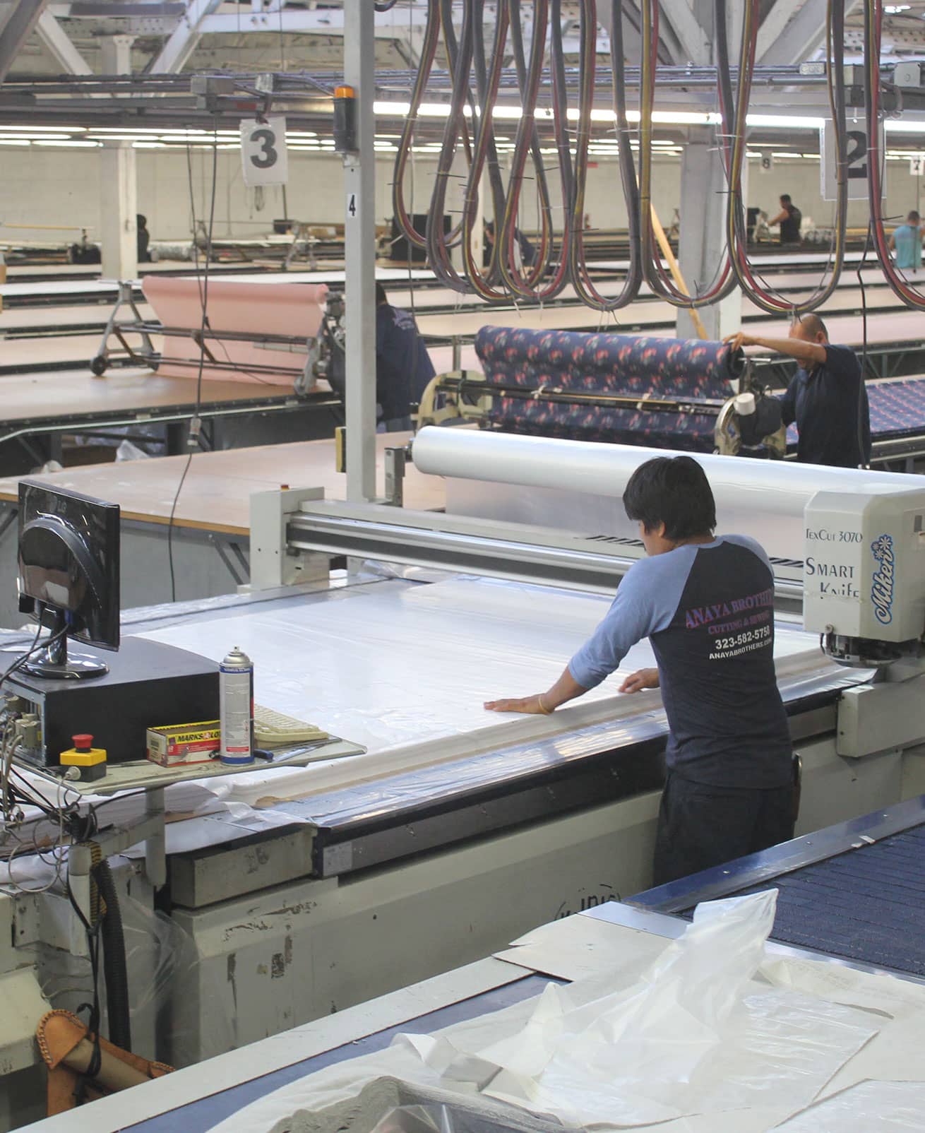 person operating automatic fabric cutting machine